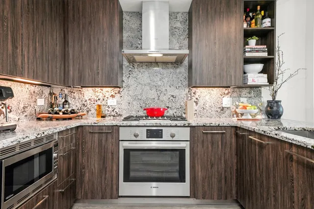a kitchen with stainless steel appliances granite countertop a stove and a sink