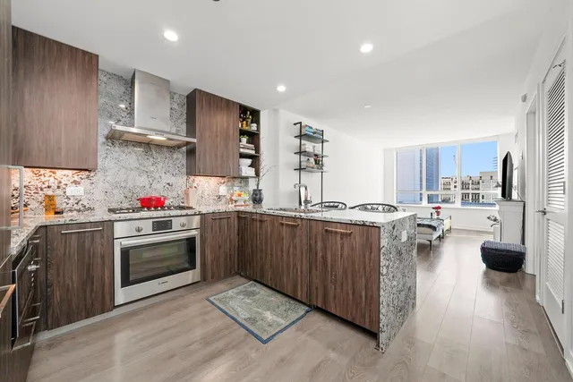 a kitchen with stove and cabinets
