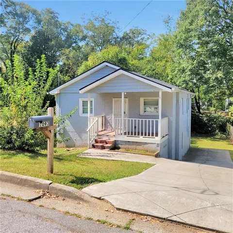 a house with swimming pool in front of it