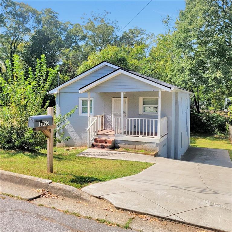 1093 Windsor Street Southwest Atlanta, GA 30310 - Photo 1 of 18 a house with swimming pool in front of it