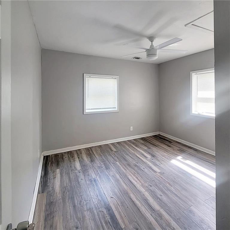 1093 Windsor Street Southwest Atlanta, GA 30310 - Photo 15 of 18 an empty room with wooden floor and windows