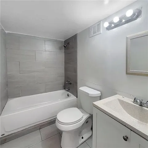 a bathroom with a toilet a sink and bathtub