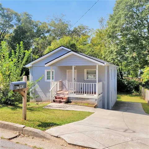 a front view of house with yard swimming pool and outdoor seating