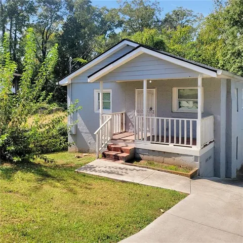 a view of house with backyard and garden
