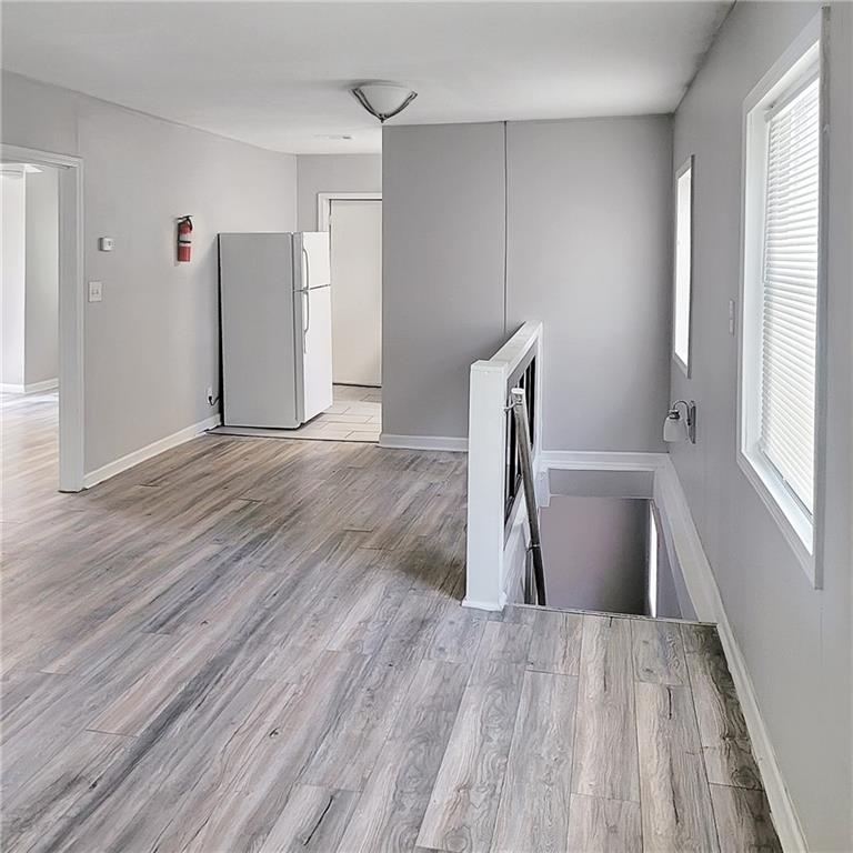 1093 Windsor Street Southwest Atlanta, GA 30310 - Photo 6 of 18 a view of empty room with wooden floor and window