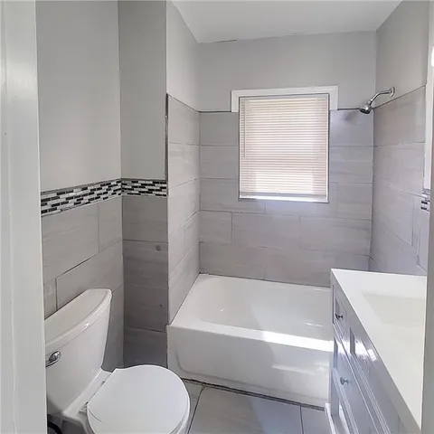 a bathroom with a toilet bathtub and shower