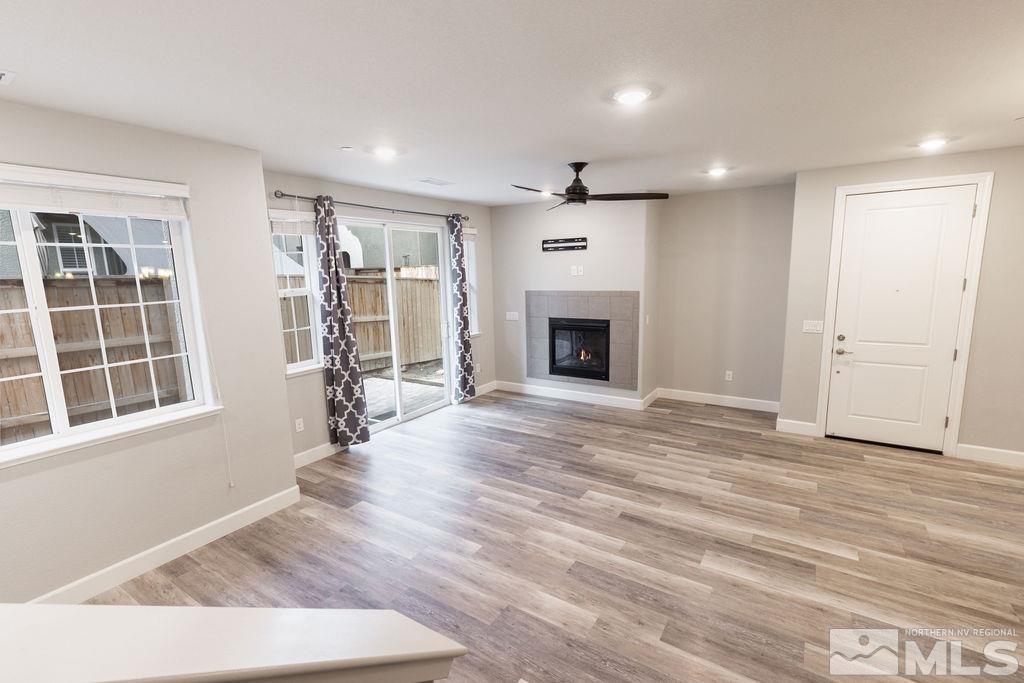 1845 Dark Horse Road, Unit B Reno, NV 89521 - Photo 1 of 25 wooden floor in an empty room with a fireplace