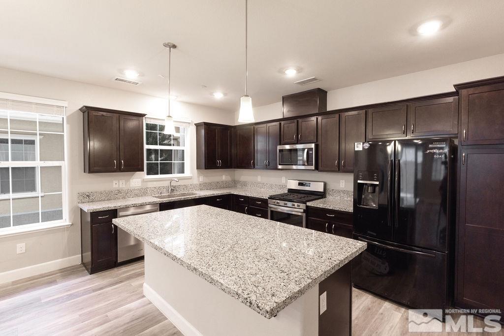 1845 Dark Horse Road, Unit B Reno, NV 89521 - Photo 3 of 25 a kitchen with stainless steel appliances granite countertop a sink stove and refrigerator