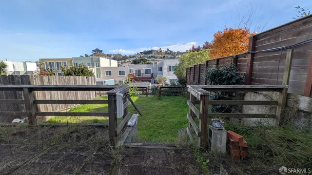 a backyard of a house with a garden and outdoor seating