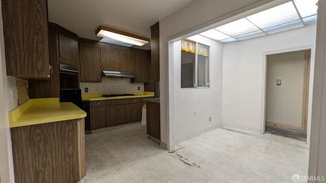 a kitchen with a sink a stove and cabinets