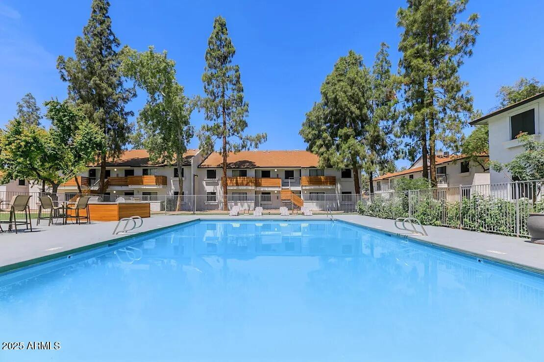 a view of a swimming pool with an outdoor seating