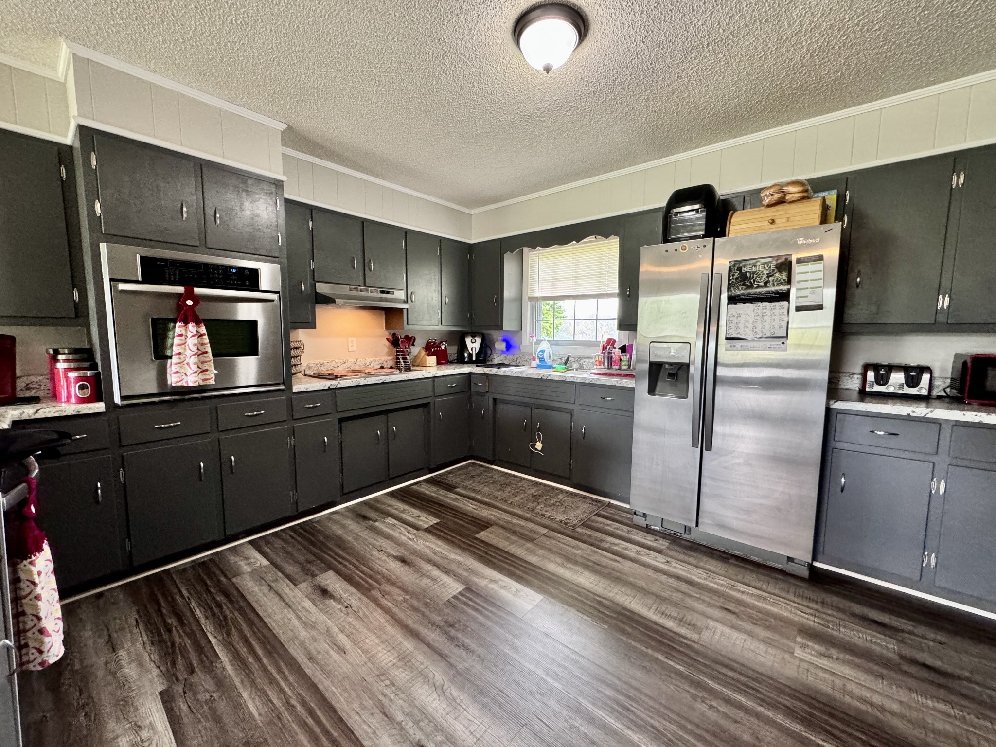 802 Days Road Lafayette, TN 37083 - Photo 7 of 25 a kitchen with stainless steel appliances a refrigerator and wooden cabinets