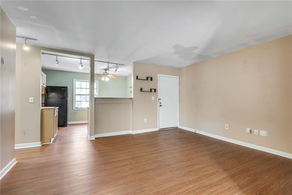 134 Lablanc Way Northwest Atlanta, GA 30327 - Photo 6 of 42 a view of a kitchen with a fridge and wooden floor