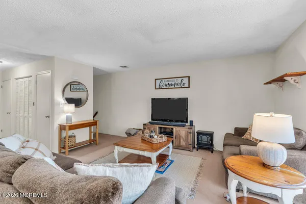 a bedroom with furniture and a flat screen tv