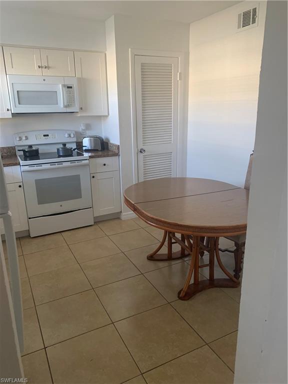 a kitchen with a sink cabinets and appliances