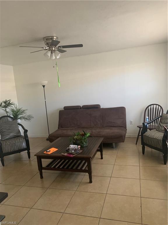 3325 Airport-Pulling Road North, Unit L1 Naples, FL 34105 - Photo 3 of 10 a living room with furniture and a potted plant