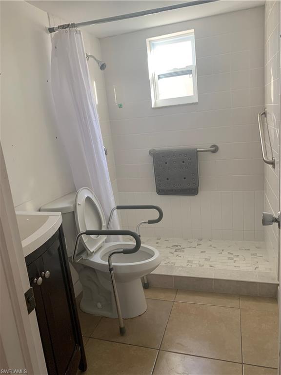 3325 Airport-Pulling Road North, Unit L1 Naples, FL 34105 - Photo 4 of 10 a bathroom with a granite countertop sink toilet and shower