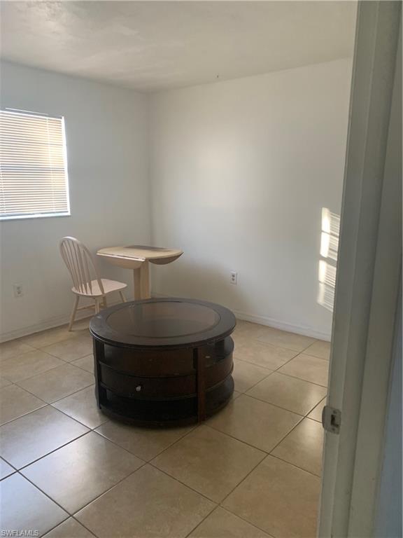 3325 Airport-Pulling Road North, Unit L1 Naples, FL 34105 - Photo 6 of 10 a room with a table and window