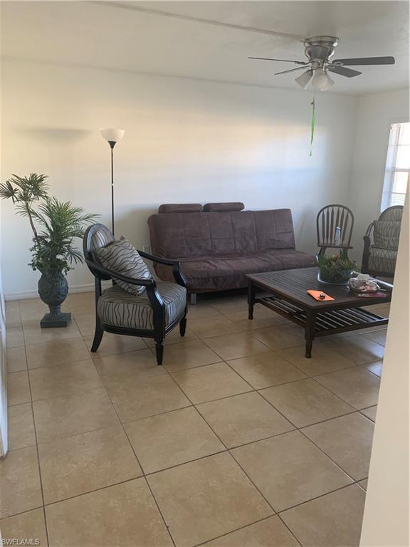 3325 Airport-Pulling Road North, Unit L1 Naples, FL 34105 - Photo 8 of 10 a living room with furniture and a potted plant