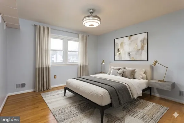 a bedroom with a large bed and a chandelier