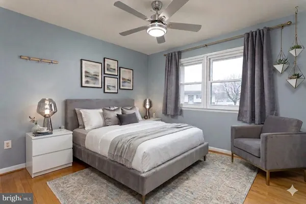 a bedroom with a large bed couch and a window