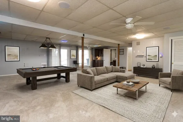 a living room with furniture a rug and a chandelier