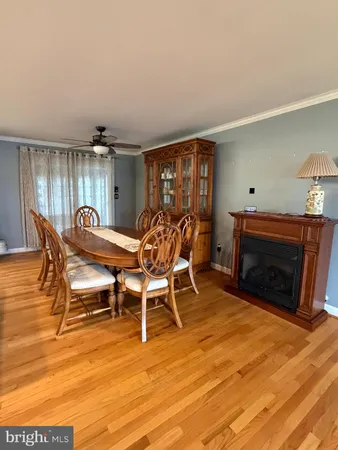 a dining room with furniture and wooden floor