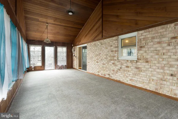 a view of an empty room with windows