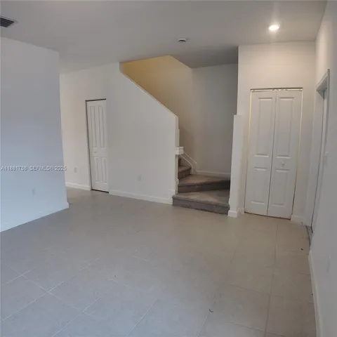 a view of kitchen with windows and closet