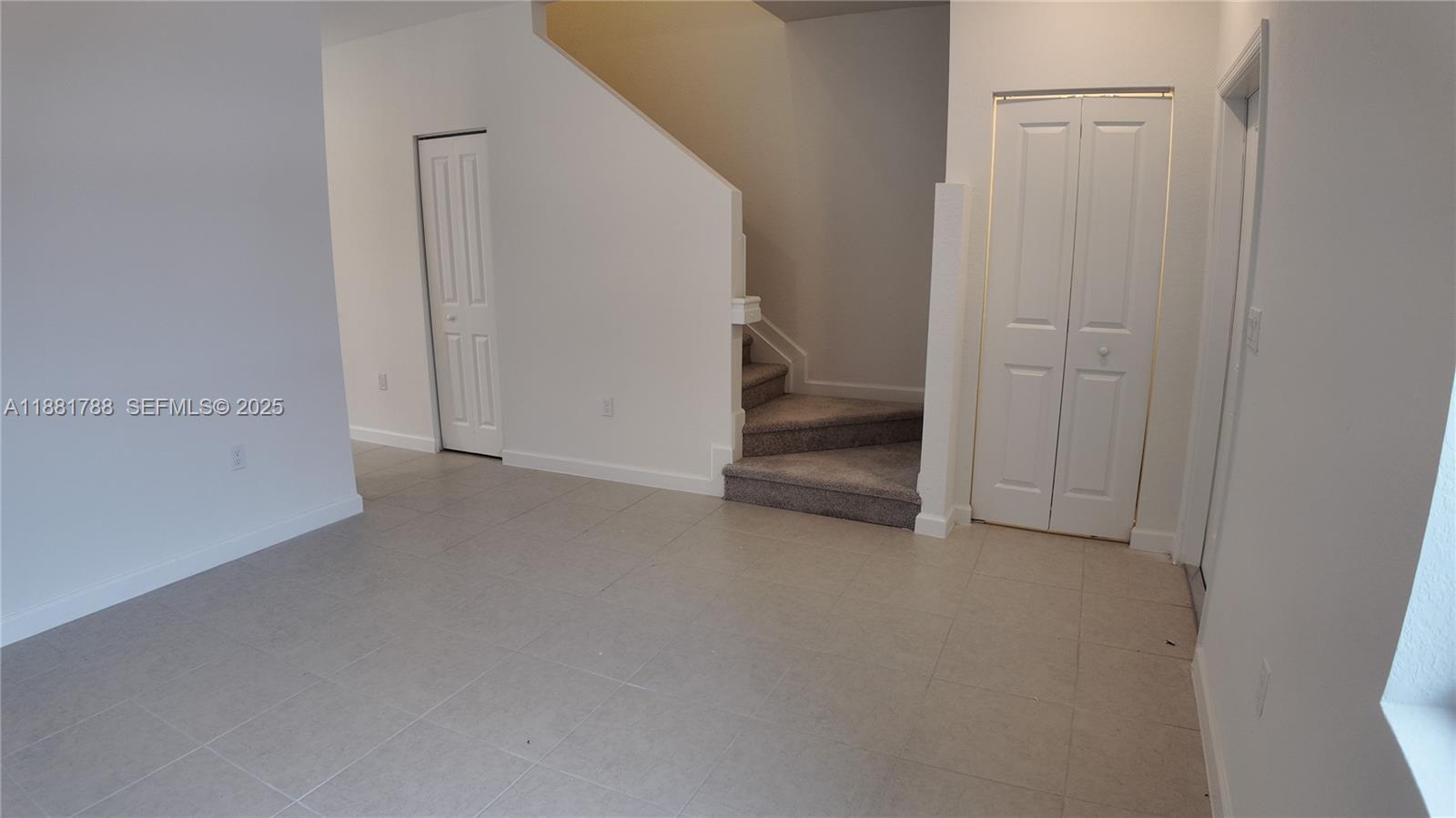 35761 Southwest 178th Court, Unit 35761 Homestead, FL 33034 - Photo 14 of 80 a view of a room with an empty space and the hallway