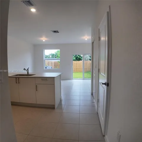 a kitchen with refrigerator and cabinets