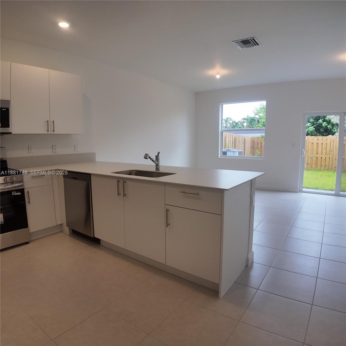 35761 Southwest 178th Court, Unit 35761 Homestead, FL 33034 - Photo 18 of 80 a kitchen with a sink cabinets and window