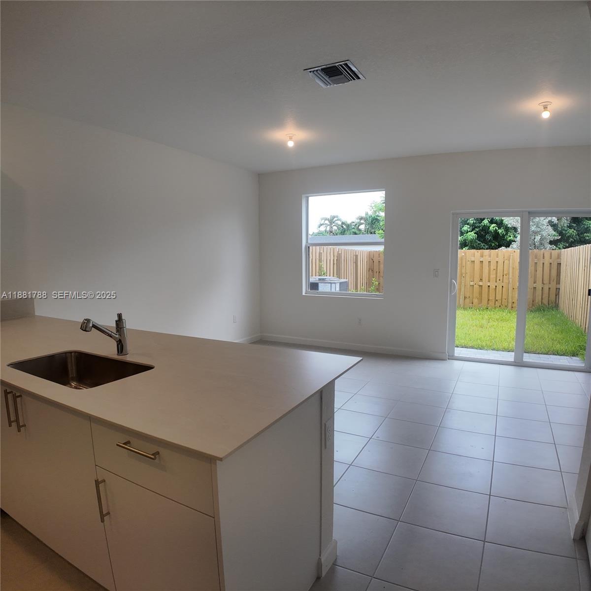 35761 Southwest 178th Court, Unit 35761 Homestead, FL 33034 - Photo 19 of 80 a kitchen with a sink a counter top space and cabinets