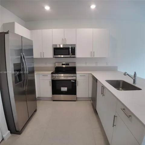 a kitchen with a sink and a window