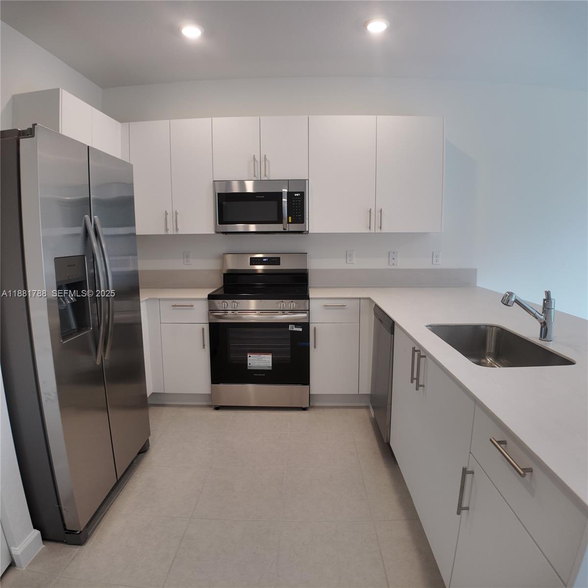 35761 Southwest 178th Court, Unit 35761 Homestead, FL 33034 - Photo 20 of 80 a kitchen with stainless steel appliances a refrigerator stove and sink