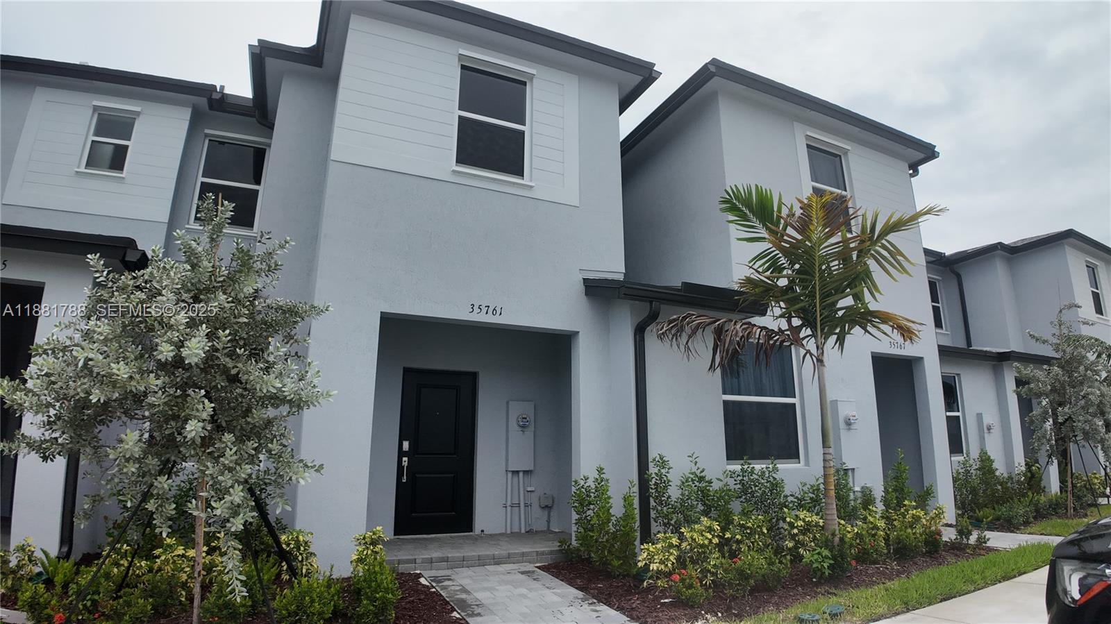35761 Southwest 178th Court, Unit 35761 Homestead, FL 33034 - Photo 2 of 80 a front view of house with yard
