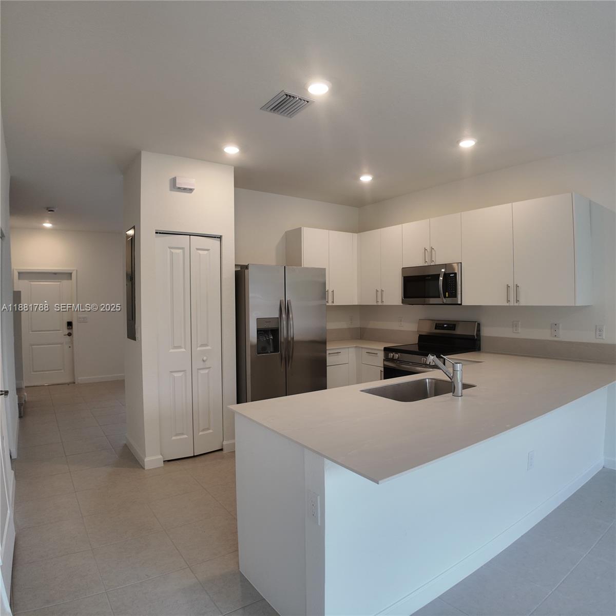35761 Southwest 178th Court, Unit 35761 Homestead, FL 33034 - Photo 21 of 80 a kitchen with refrigerator and cabinets