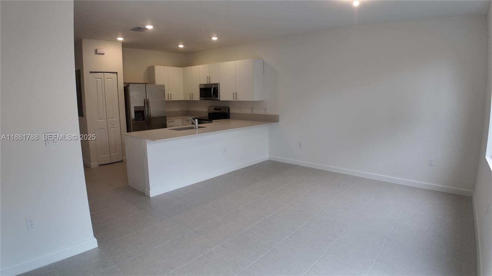 35761 Southwest 178th Court, Unit 35761 Homestead, FL 33034 - Photo 28 of 80 a kitchen with stainless steel appliances a refrigerator sink and microwave