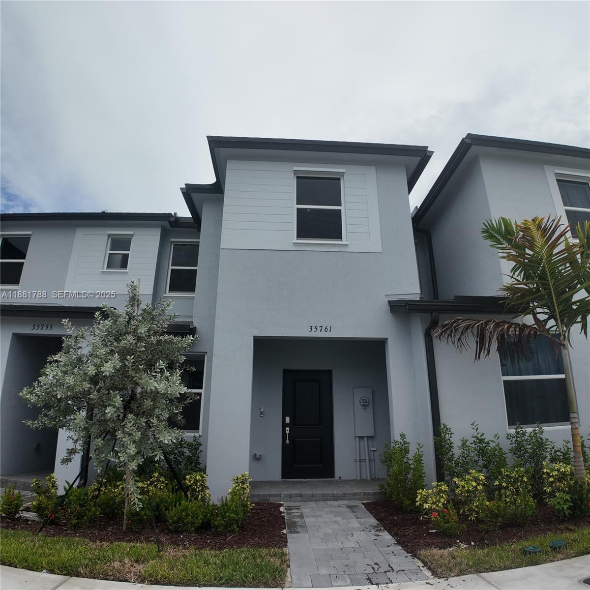 35761 Southwest 178th Court, Unit 35761 Homestead, FL 33034 - Photo 3 of 80 a front view of a house with garden
