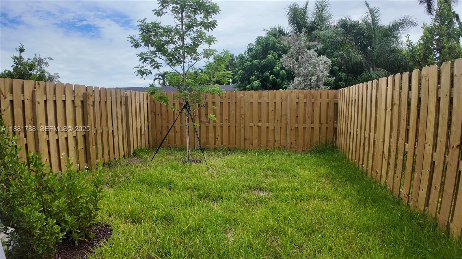 35761 Southwest 178th Court, Unit 35761 Homestead, FL 33034 - Photo 34 of 80 a view of a backyard with wooden fence