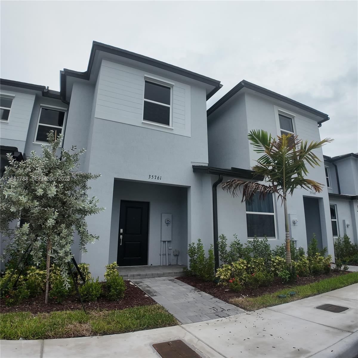 35761 Southwest 178th Court, Unit 35761 Homestead, FL 33034 - Photo 4 of 80 a front view of a house with garden