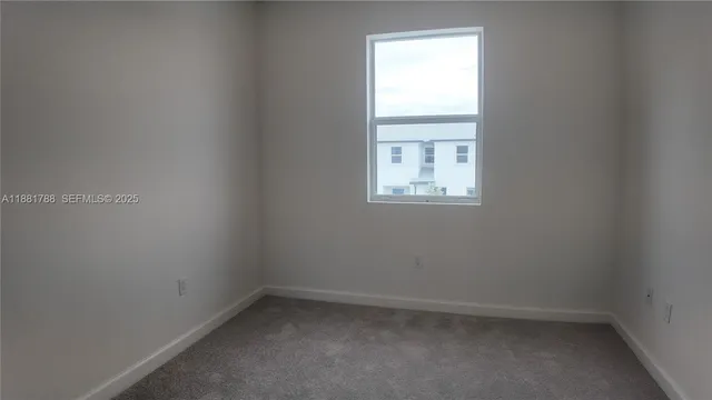 a kitchen with kitchen island granite countertop a refrigerator a sink a stove a microwave and cabinets