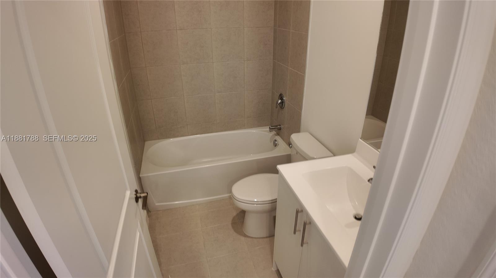 35761 Southwest 178th Court, Unit 35761 Homestead, FL 33034 - Photo 45 of 80 a white toilet sitting next to a bath tub