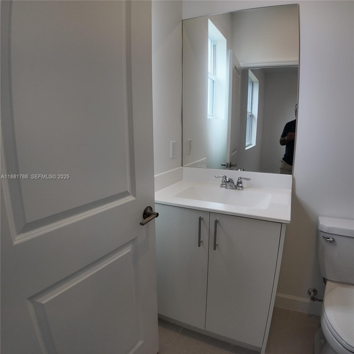 35761 Southwest 178th Court, Unit 35761 Homestead, FL 33034 - Photo 50 of 80 a bathroom with a sink mirror vanity and toilet