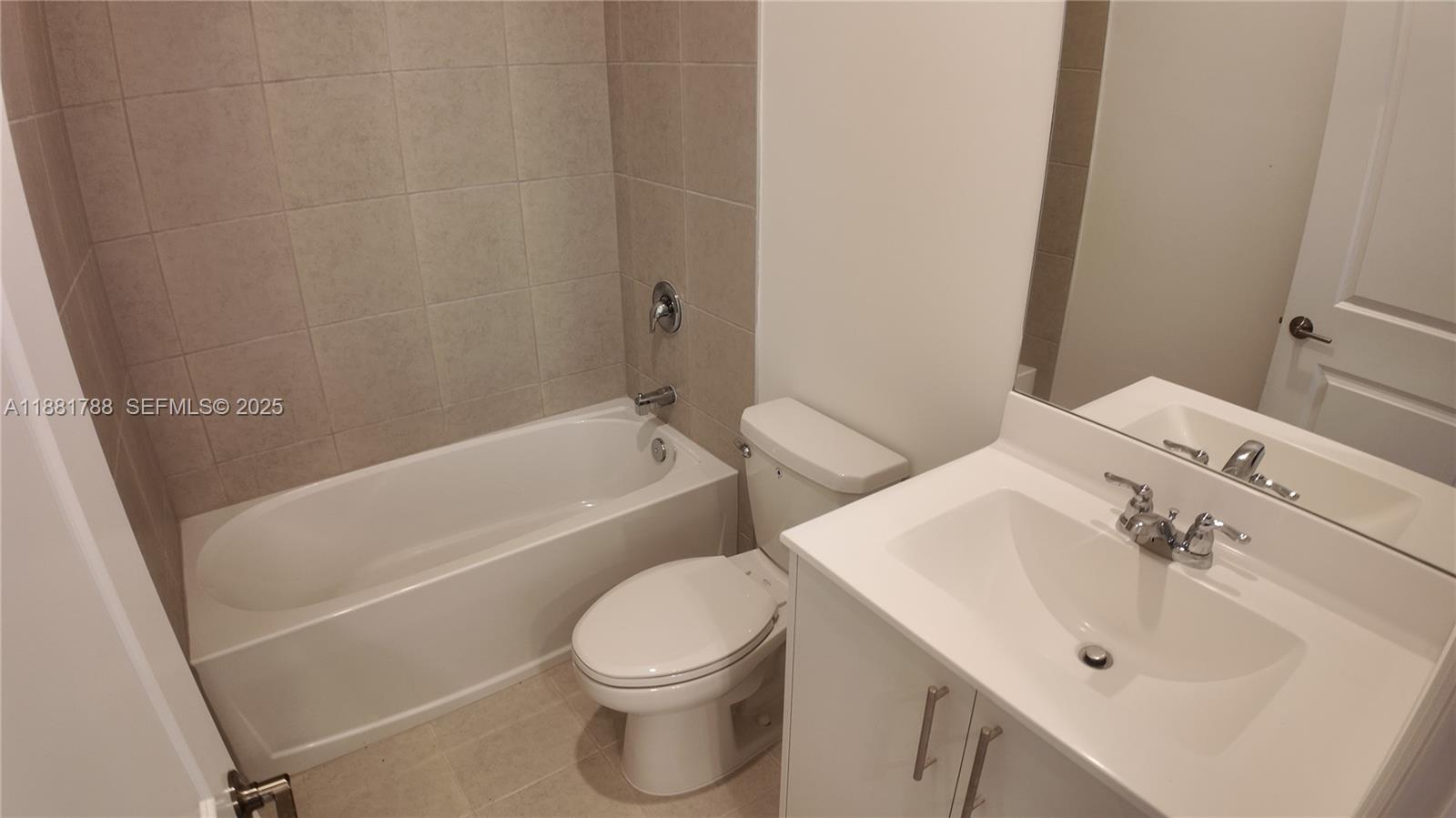 35761 Southwest 178th Court, Unit 35761 Homestead, FL 33034 - Photo 56 of 80 a bathroom with a sink a toilet and bathtub