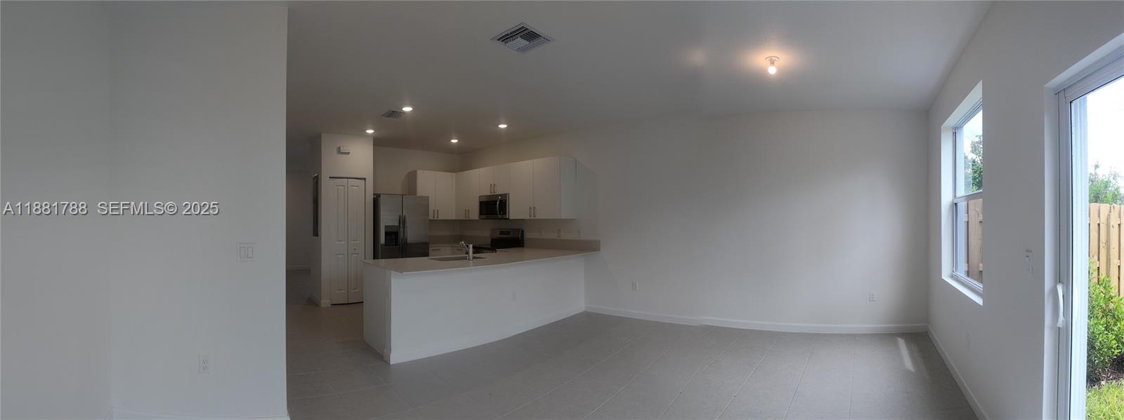35761 Southwest 178th Court, Unit 35761 Homestead, FL 33034 - Photo 58 of 80 a view of a hallway to a room and a window