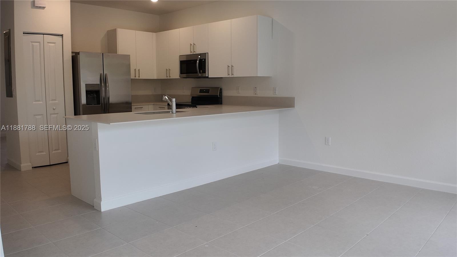 35761 Southwest 178th Court, Unit 35761 Homestead, FL 33034 - Photo 78 of 80 a kitchen with stainless steel appliances a refrigerator sink and microwave