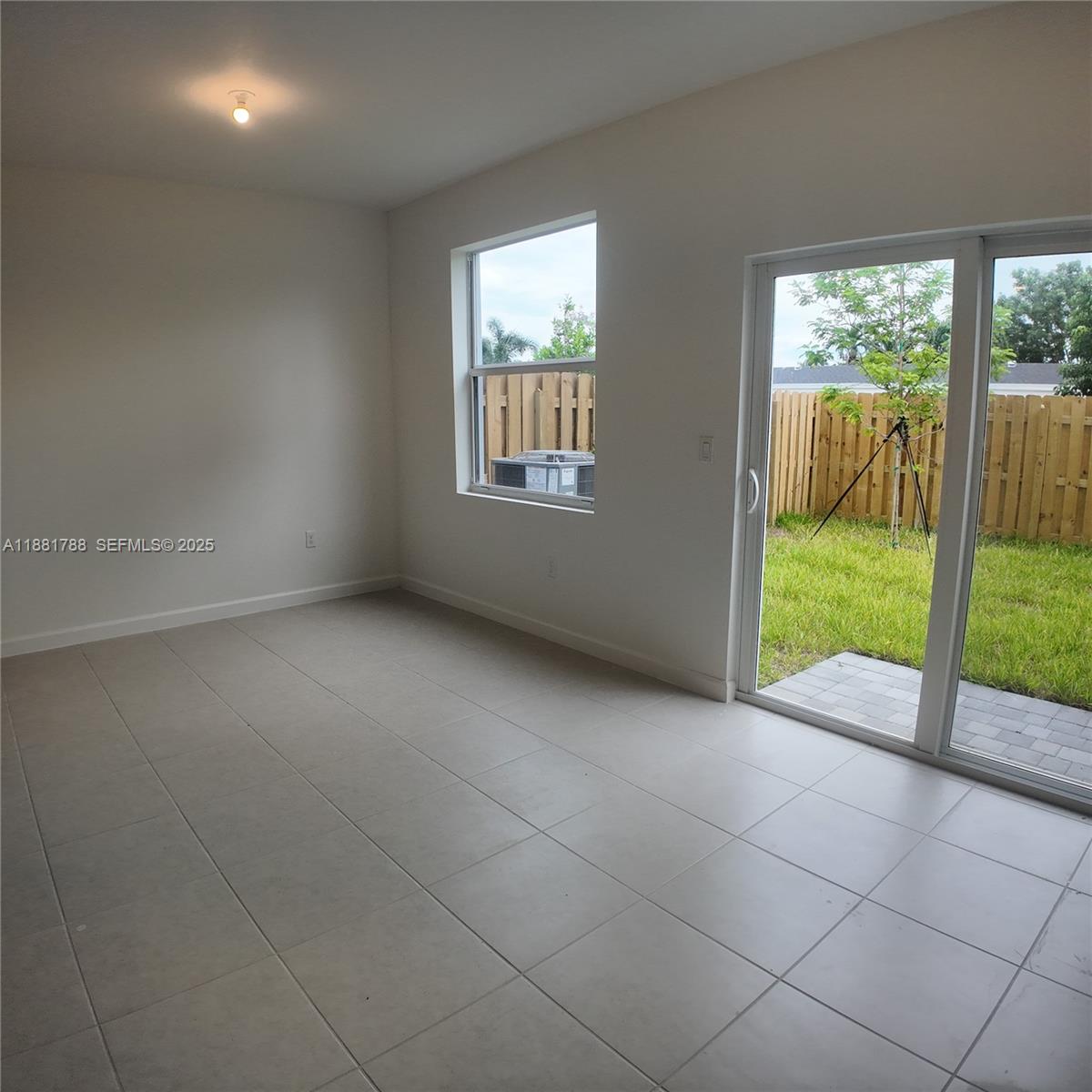 35761 Southwest 178th Court, Unit 35761 Homestead, FL 33034 - Photo 8 of 80 a view of an empty room with floor to ceiling windows