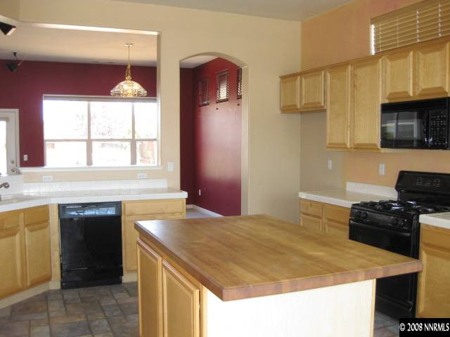 1595 Sutterbrook Way Reno, NV 89521 - Photo 4 of 9 a kitchen with a sink a stove and a refrigerator