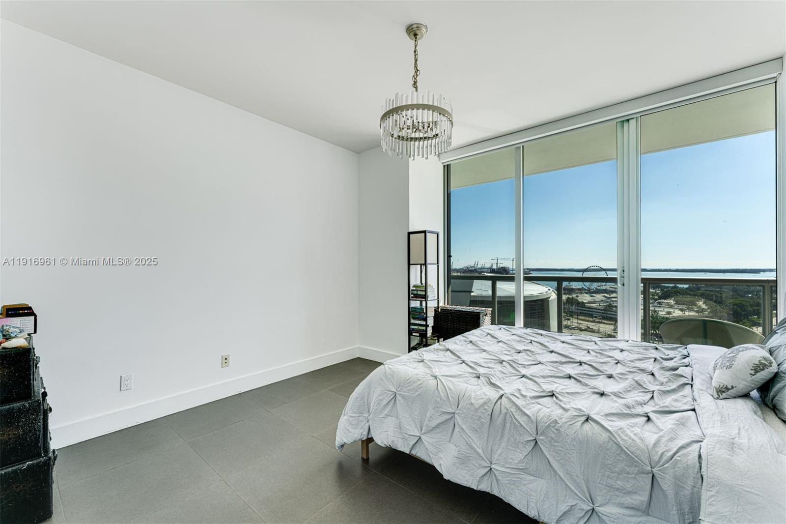 888 Biscayne Boulevard, Unit 1704 Miami, FL 33132 - Photo 11 of 20 a bedroom with a bed and a large window